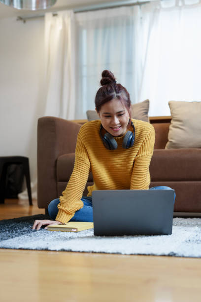 istock Portrait of a young Asian woman using a computer on the sofa 1427421397