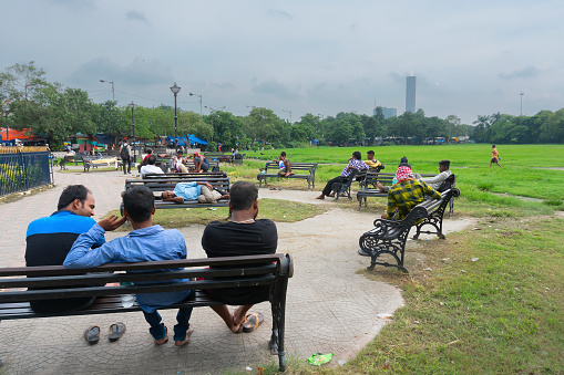 Kolkata, West Bengal, India - 10th September 2019 : Citizens of Kolkata resting and enjoying their time at esplanade, near Kolkata maidan.