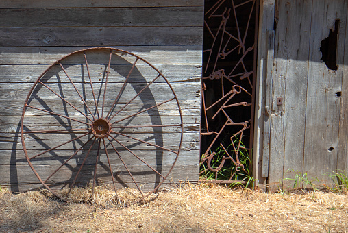 Rusted iron wheel in front of abandoned tool shed on Santa Cruz Island in the Channel Islands National Park near Santa Barbara California in the United States