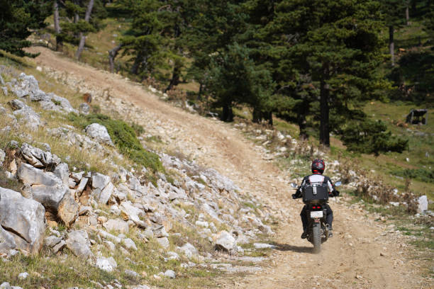 istock A man riding an off-road motorcycle on a mountain road 1427435605