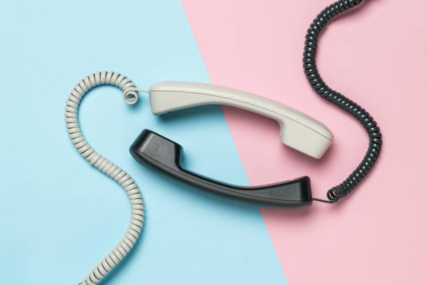 istock Light and dark handsets on a blue and pink background. Flat lay. 1427438938