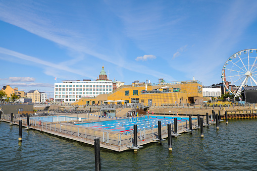 Swimmers enjoying the baltic sea pools in the harbor of Helsinki on a bright sunny day
