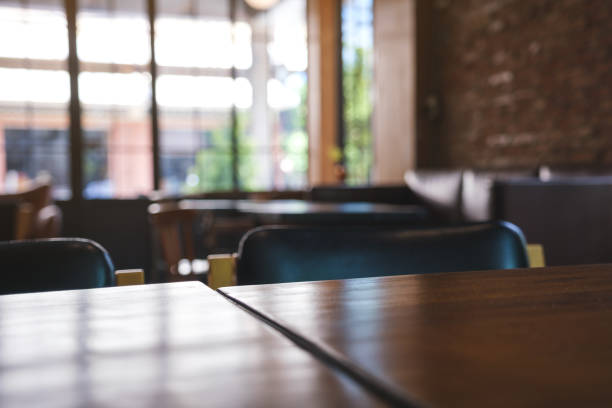 istock Wooden table top with blurred background in cafe 1427442276