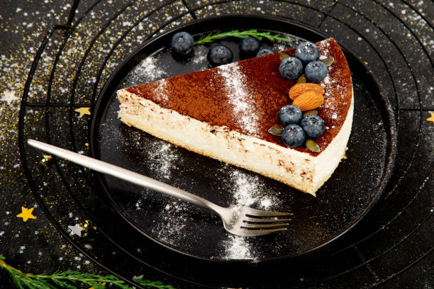 istock Christmas cake slice on dark background. 1427444466