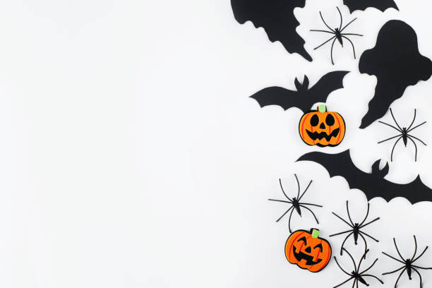 istock Halloween. Black ghosts, spiders, bats and orange pumpkins decorations on white background flat lay. Happy Halloween! Card template with space for text. Stylish minimal border 1427445262
