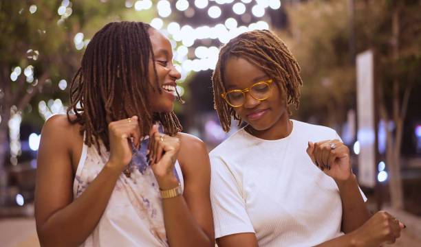 istock Twin sisters having fun and dancing in a park at night 1427445404