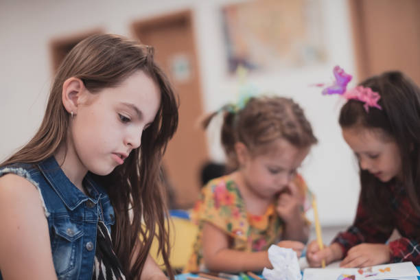 istock Creative kids sitting in a preschool institution, draw and have fun while they get an education 1427456078