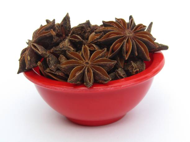 istock Star anise in a red bowl isolated on white background 1427461865