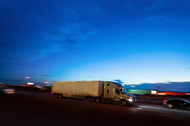 istock Semi-truck transporting merchandising at night  - panning motion blur 1427468197