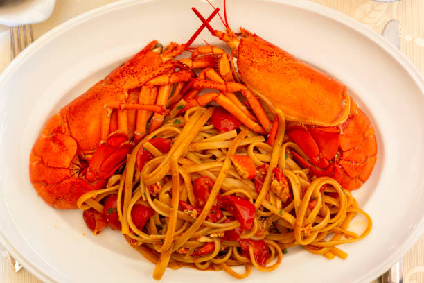 istock Italian pasta Linguine with lobster and tomatoes. Top view. 1427471230