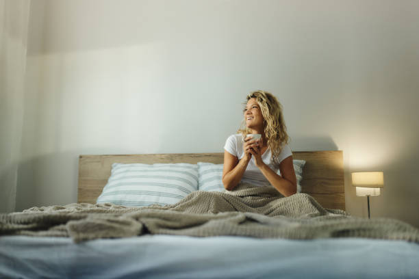 istock Happy woman day dreaming during coffee time in bed. 1427471644