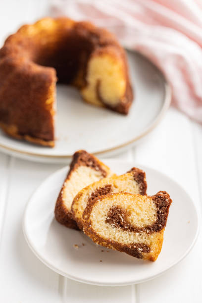 istock Sweet sponge cake. Bundt cake on plate on white table. 1427472902
