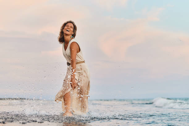 istock Playful woman having fun at sea on the beach. 1427473796