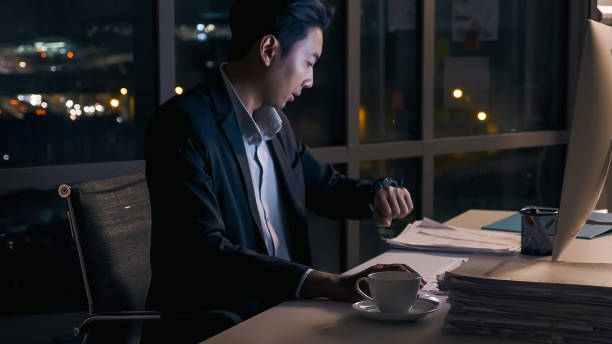 istock Stressed young Asian businessman working overtime at the office. 1427475511