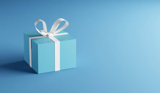 istock Blue gift box with white ribbon on blue background with copy space. 1427478763