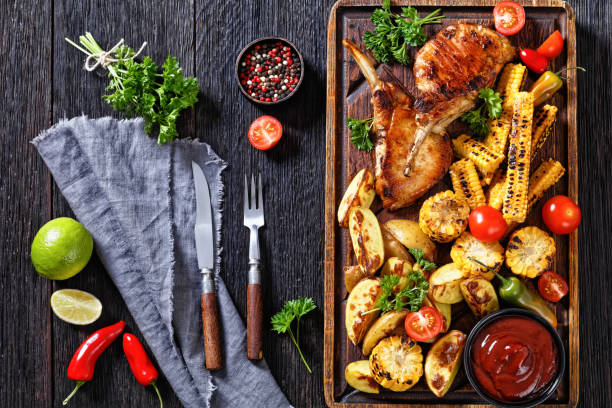 istock bbq tomahawk pork chop with corn and potatoes 1427479251