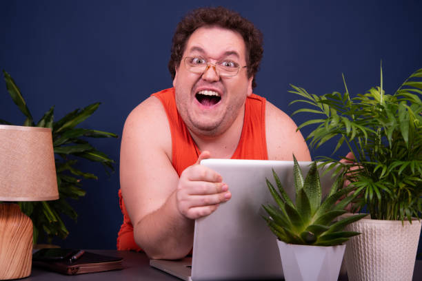 a man watches an adult video online. - sex webcam sites 個照片及圖片檔