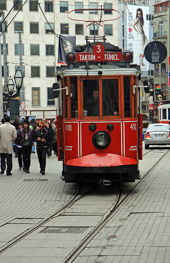 Istanbul, Turkey-April 7,2008:Traditional Turkish Red Tram heading to Taksim  from Galata  and walking People