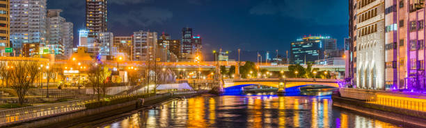 istock Neon night cityscape skyscrapers illuminated waterfront riverside panorama Osaka Japan 1427482600