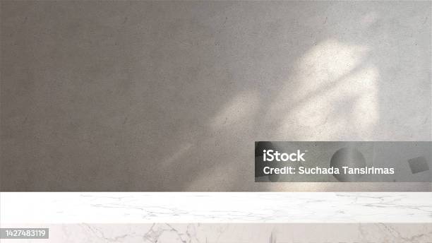 White Marble Tabletop Or Countertop In Loft Modern And Minimal Concrete Wall Room With Sunlight And Tree Shadow From Window At Home Stock Photo - Download Image Now