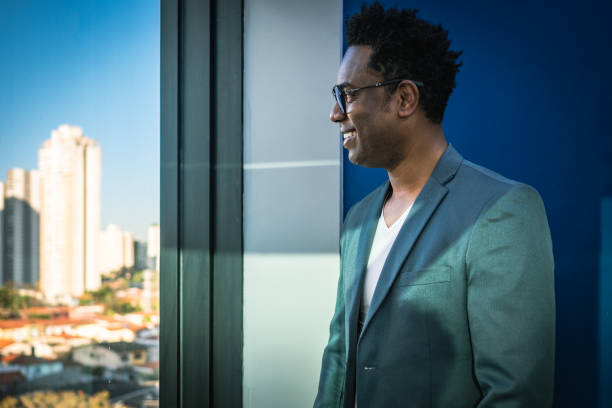 istock Business man looking out the window happy 1427483241