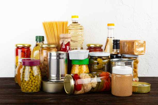 emergency survival food set on dark wooden kitchen table - non perishable imagens e fotografias de stock