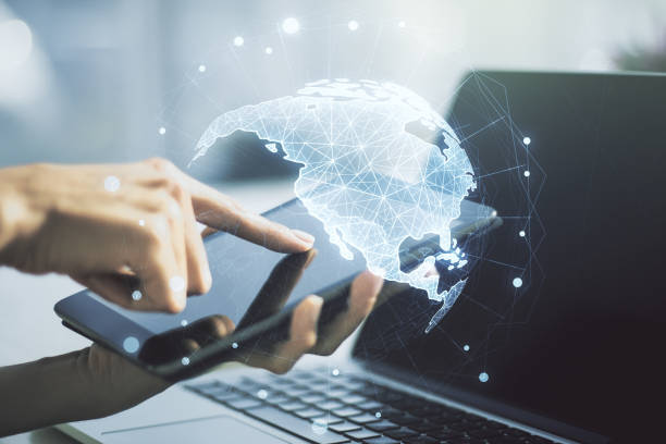 istock Digital America map and finger presses on a digital tablet on background, global technology concept. Multiexposure 1427493787