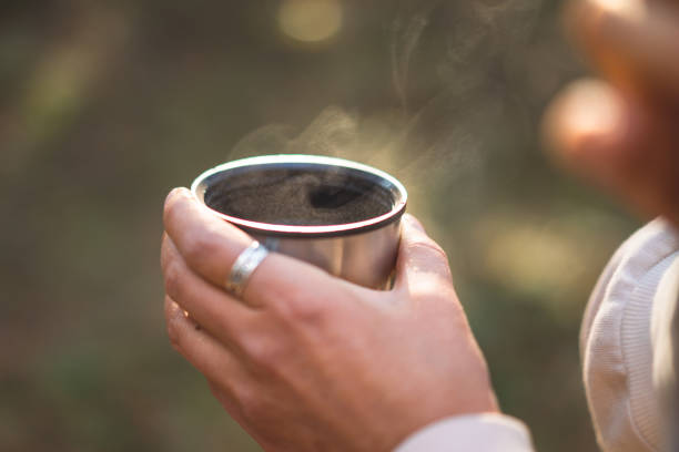 istock young woman drinking tea in a pine forest 1427494373