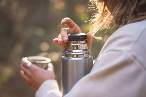 istock young woman pouring tea in a pine forest 1427494577