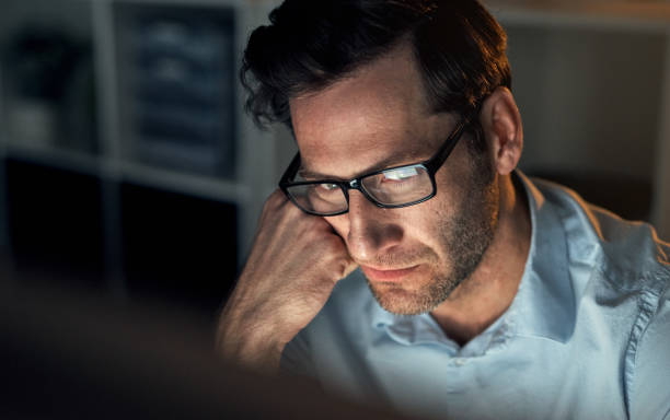 istock Stress, anxiety and burnout man working at night to finish deadline project delay at work. Depression, frustrated or mental health of corporate person sad and tired of research at corporate business 1427498899