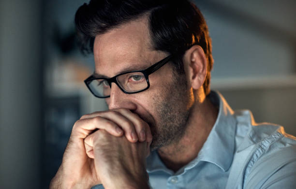 istock Businessman, stress and anxiety with computer in night office planning seo code or reading database analytics. Technology engineer, software programmer or website designer with mental health burnout 1427498902