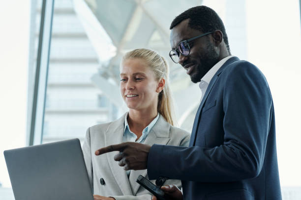 istock Young confident businessman pointing at online data on laptop screen 1427499231