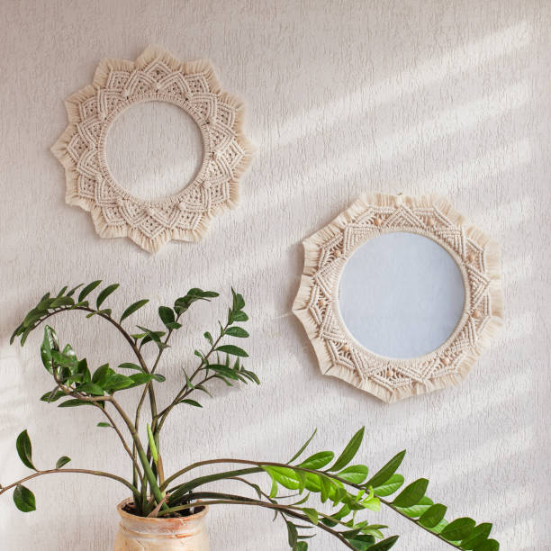 istock Macrame mirror and wreath on a white wall.  Eco-style. Natural materials. 1427499704