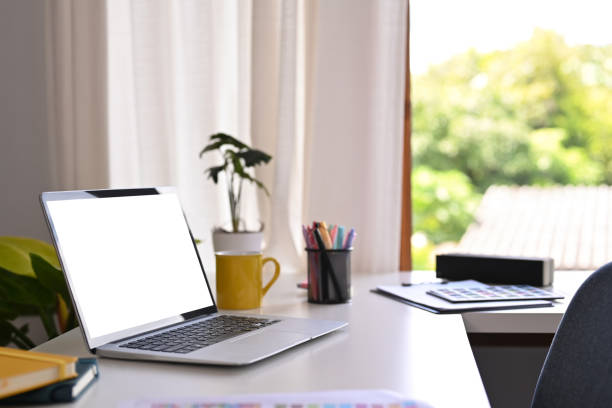 istock Creative working desk with laptop computer, coffee cup, stationery and potted plant. 1427500504