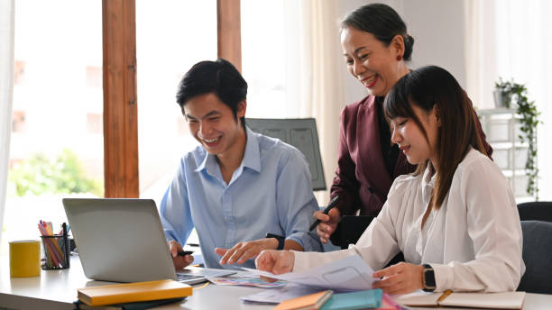 istock Senior manager and young creative team brainstorming, working together on mobile application software design project at office. 1427500524