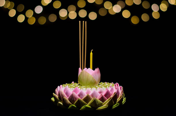 Lotus flower of pink lotus petal krathong on night background with bokeh light Selective focus on Lotus flower of pink lotus petal krathong on night background with bokeh light for Thailand full moon or Loy krathong festival. krathong stock pictures, royalty-free photos & images
