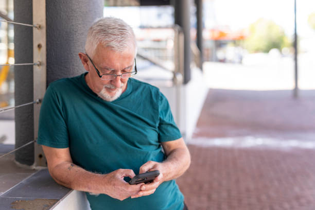 istock Senior man using a mobile phone outdoors 1427501770