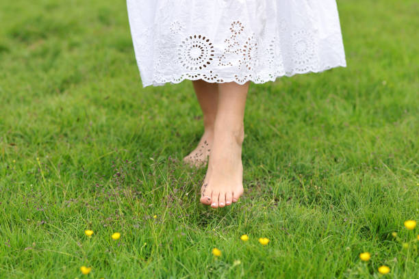 istock Woman bare feet walking on the grass 1427502897