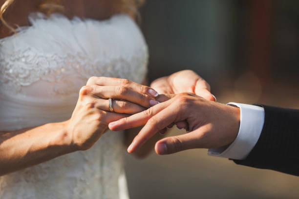 istock Bride and groom exchange rings at the wedding ceremony 1427504987