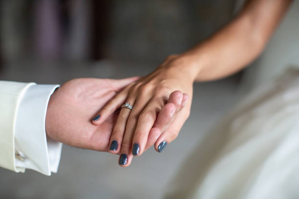 istock Engagement ring on bride's finger during wedding preparations 1427505248