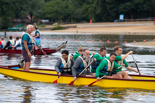 Oldenzaal, Netherlands - September 10, 2022: dragon boat races for charity purposes. A dragon boat is a human powered watercraft originating from the Pearl River Delta region of China's southern Guangdong province.