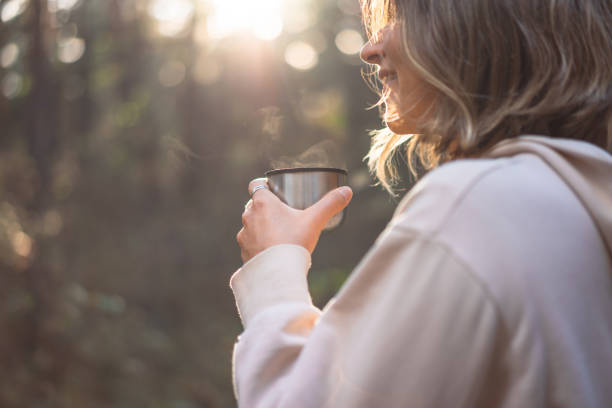 istock young woman pouring tea in a pine forest 1427506598