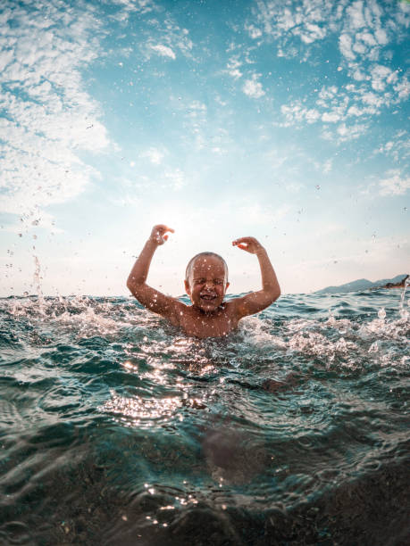 istock Young Caucasian Kid Splashing Water At The Beach 1427506679
