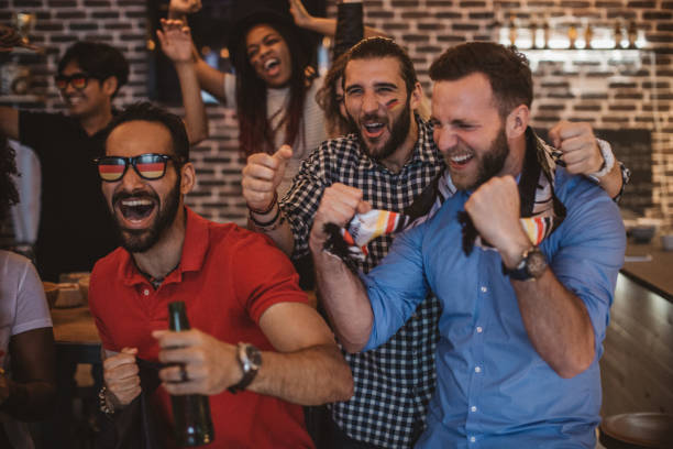 istock Soccer fans cheering at bar 1427508470
