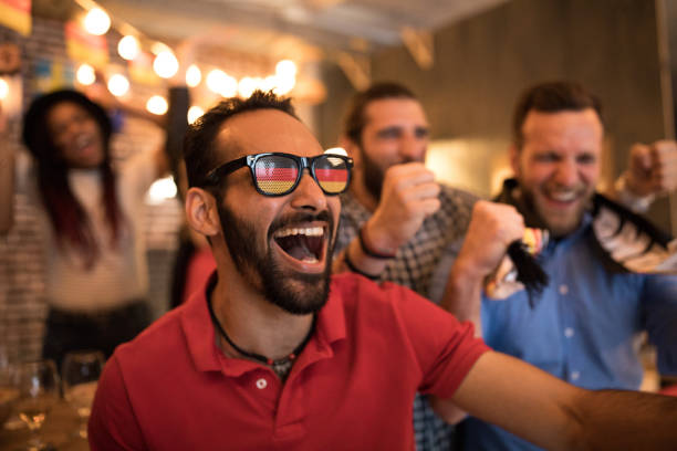 istock Soccer fans cheering at bar 1427508580
