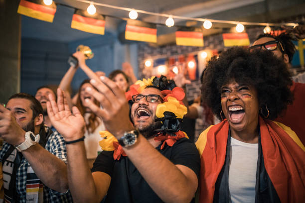 istock Soccer fans cheering at bar 1427508732
