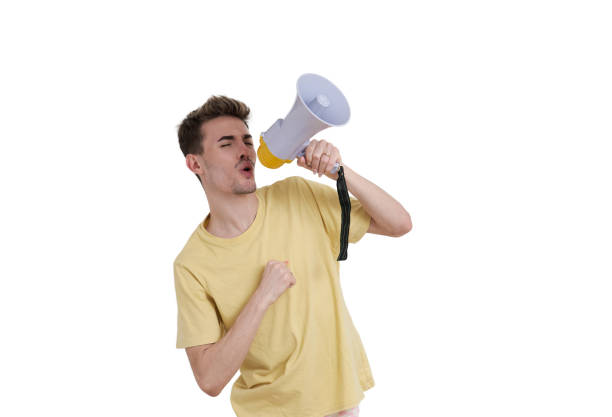 istock Young caucasian man shouting through megaphone, isolated. 1427511189