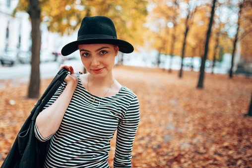 beautiful woman with hat in a autumnal park