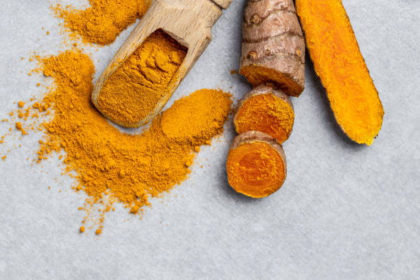 istock curcuma or curcumin root. Turmeric powder and fresh turmeric. on concrete background. Spice, natural coloring, alternative medicine. top view 1427516087