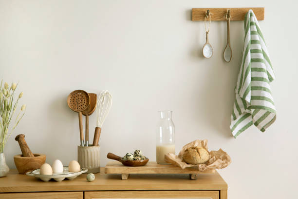 istock Interior design of kitchen space with rattan commode, milk, eggs, food and kitchen accessories in boho home decor.  Template. 1427519001